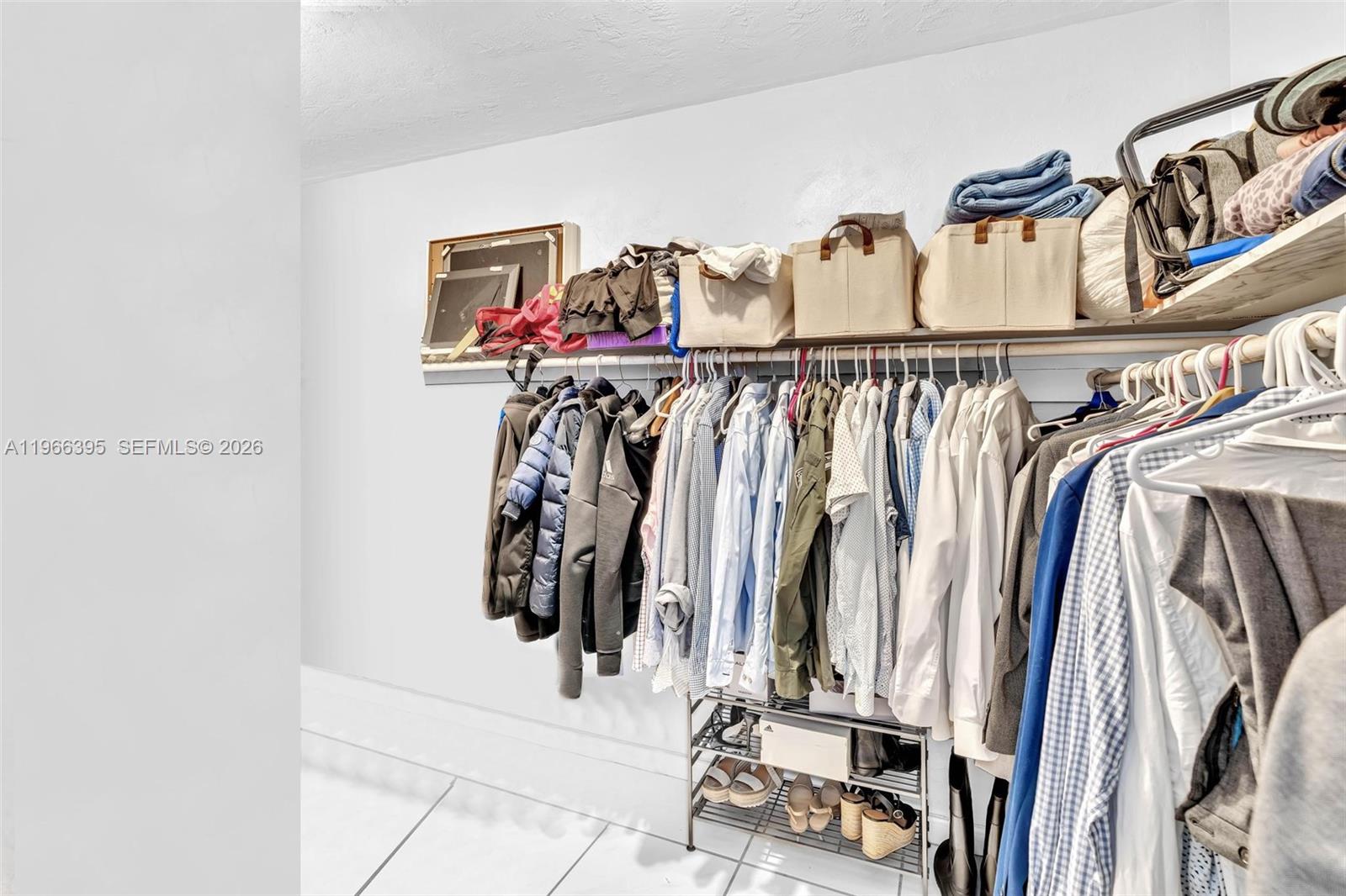 9524 Byron Avenue Surfside, FL 33154 - Photo 15 of 53 a view of walk in closet with clothes and shoes
