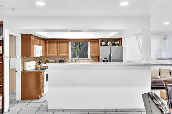 a large kitchen with a table and chairs