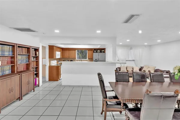 a living room with furniture flowerpot and lamp