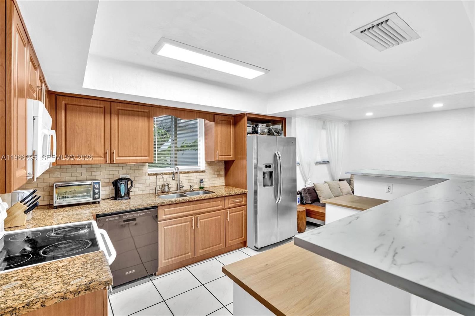 9524 Byron Avenue Surfside, FL 33154 - Photo 29 of 53 a kitchen with a sink and cabinets