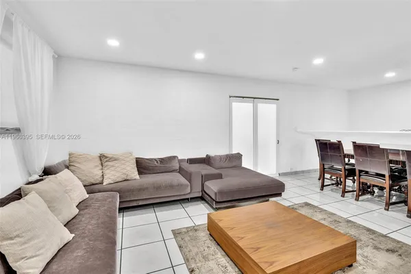 a living room with furniture and a rug