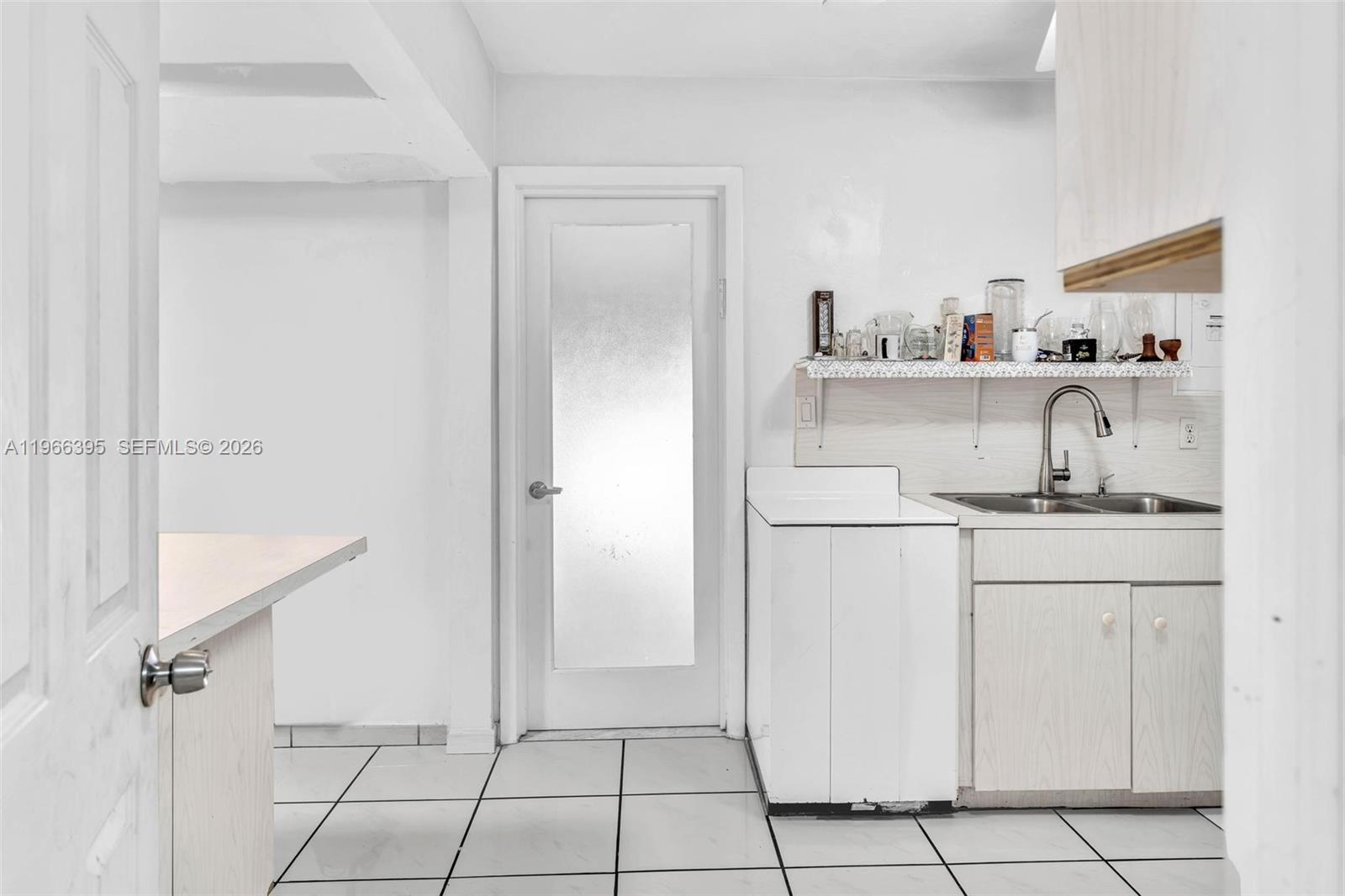 9524 Byron Avenue Surfside, FL 33154 - Photo 43 of 53 a kitchen with a sink cabinets and a refrigerator