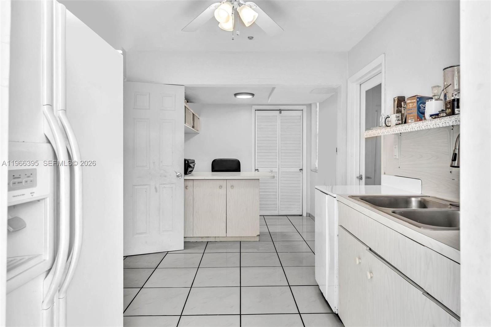 9524 Byron Avenue Surfside, FL 33154 - Photo 44 of 53 a kitchen with white cabinets and appliances