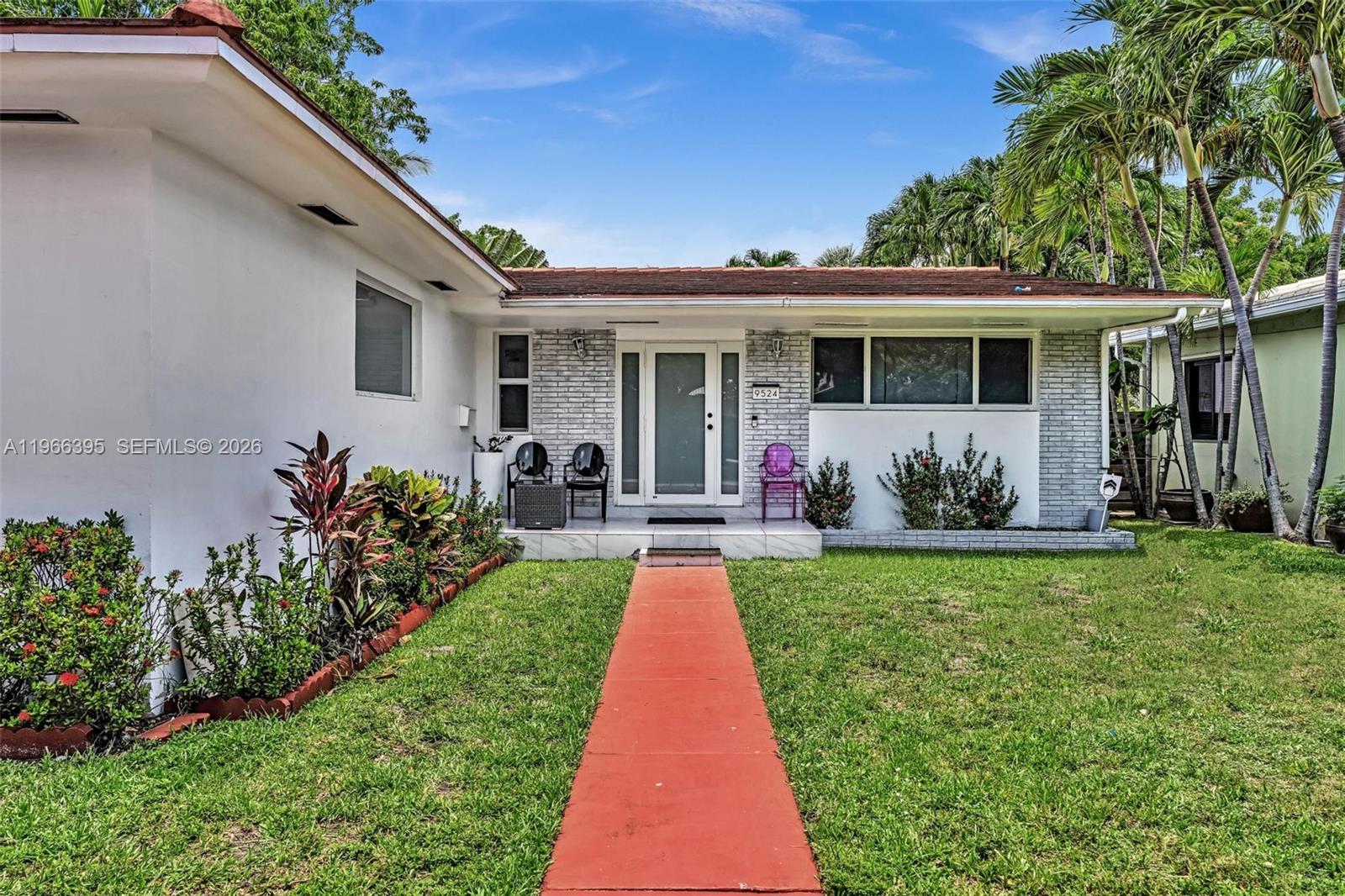 9524 Byron Avenue Surfside, FL 33154 - Photo 6 of 53 a front view of a house with a yard
