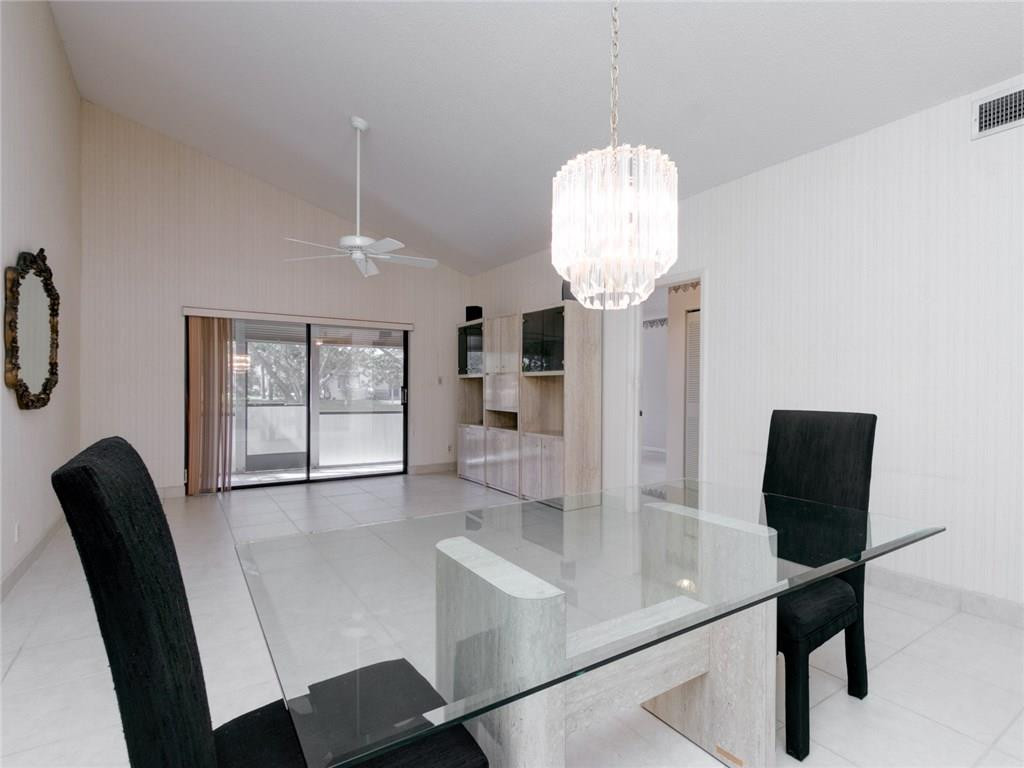 679 Racquet Club Road, Unit 4 Weston, FL 33326 - Photo 13 of 35 a view of a dining room with furniture and chandelier