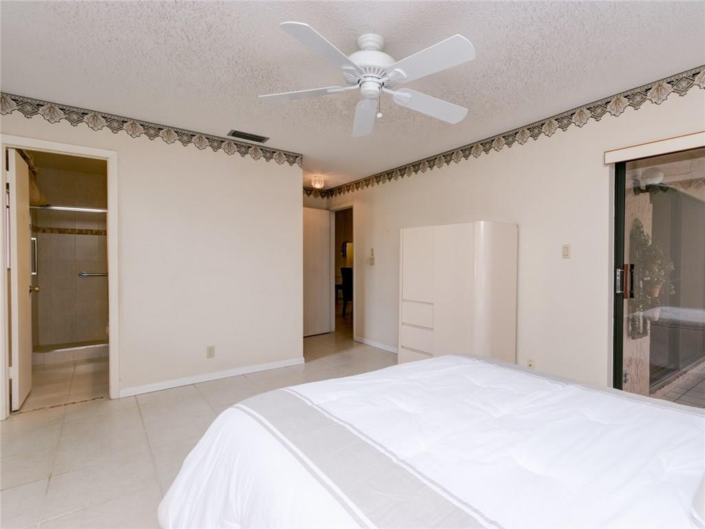 679 Racquet Club Road, Unit 4 Weston, FL 33326 - Photo 19 of 35 a bedroom with a bed and a chandelier