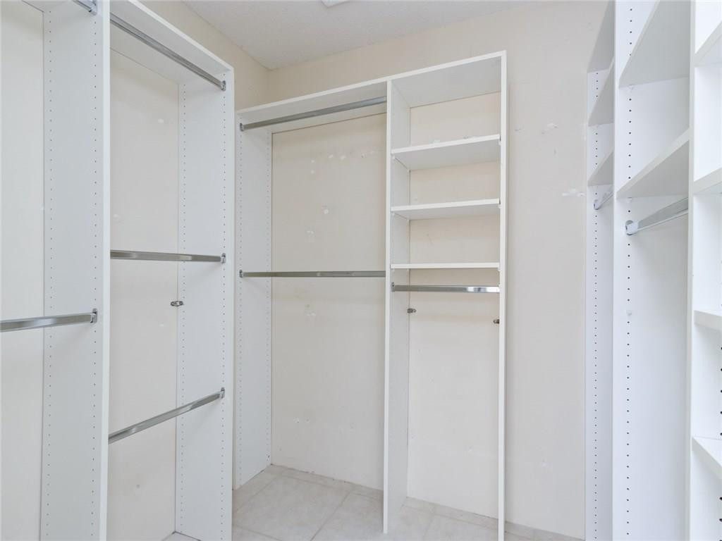 679 Racquet Club Road, Unit 4 Weston, FL 33326 - Photo 22 of 35 a view of walk in closet with empty racks