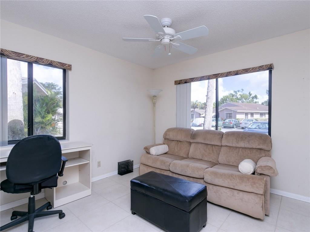 679 Racquet Club Road, Unit 4 Weston, FL 33326 - Photo 23 of 35 a living room with furniture and a large window