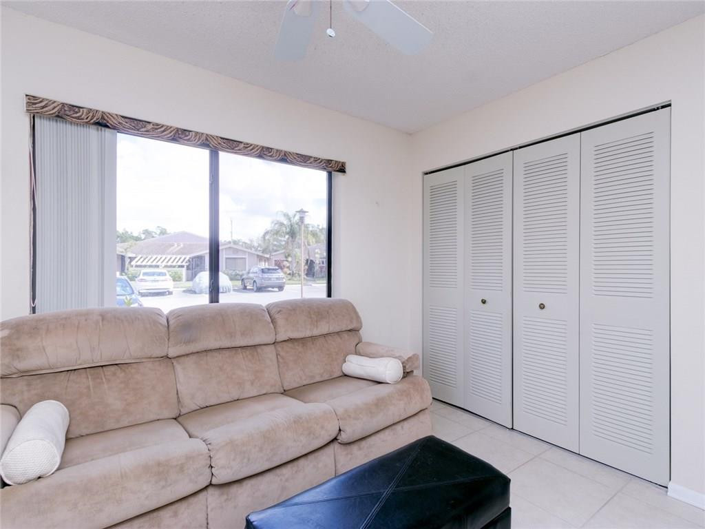 679 Racquet Club Road, Unit 4 Weston, FL 33326 - Photo 24 of 35 a living room with furniture and a large window