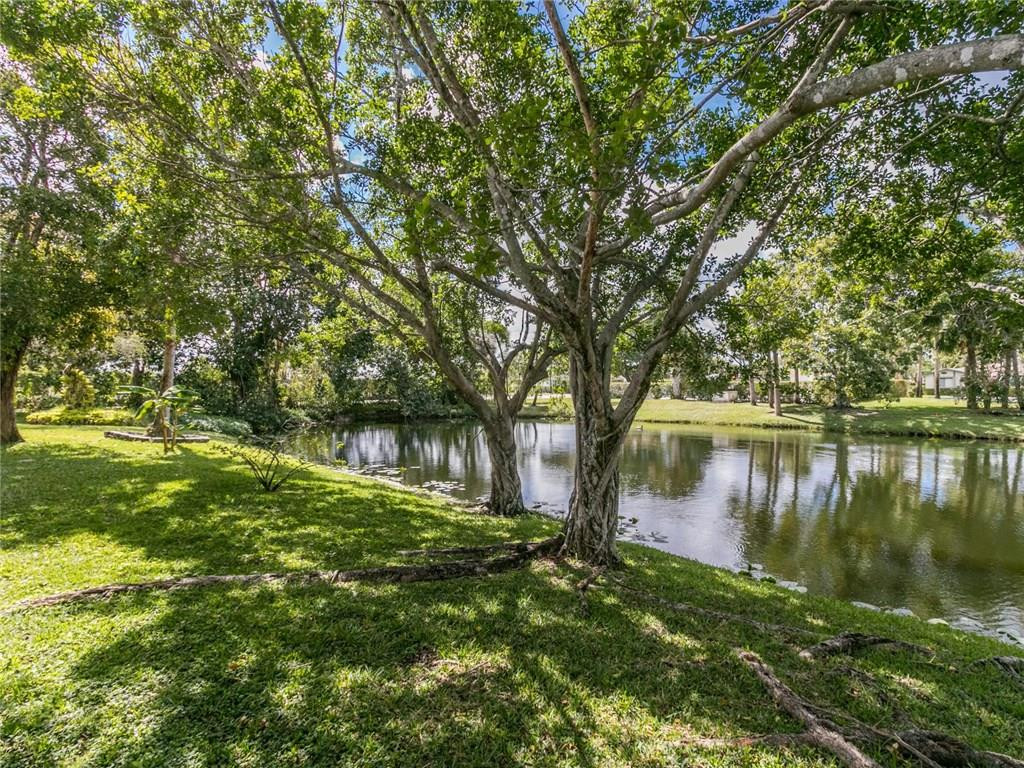 679 Racquet Club Road, Unit 4 Weston, FL 33326 - Photo 33 of 35 a backyard of a house with lots of green space and lake view
