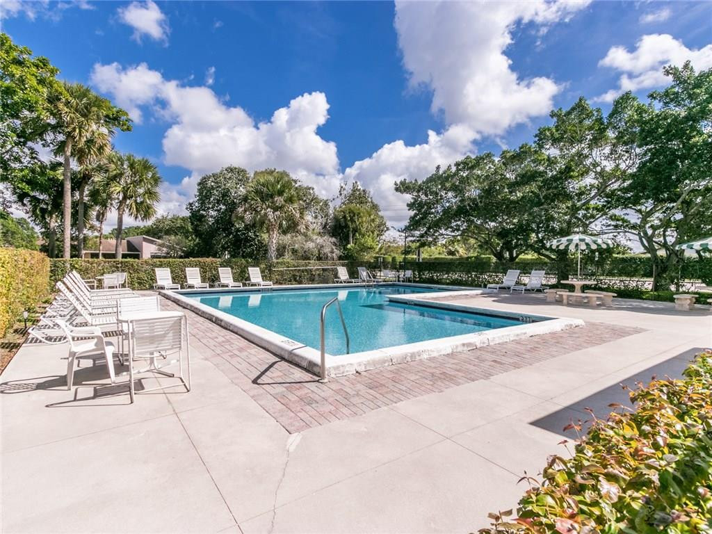 679 Racquet Club Road, Unit 4 Weston, FL 33326 - Photo 34 of 35 a view of a swimming pool with a lounge chairs