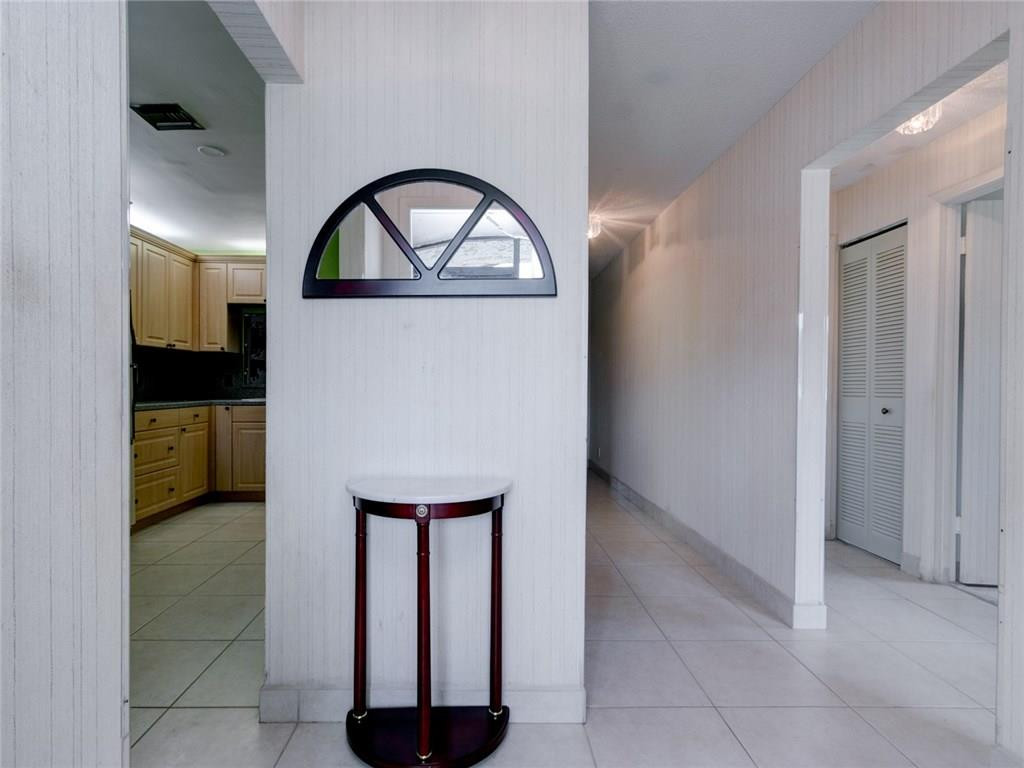 679 Racquet Club Road, Unit 4 Weston, FL 33326 - Photo 6 of 35 a view of a livingroom with a washer and dryer