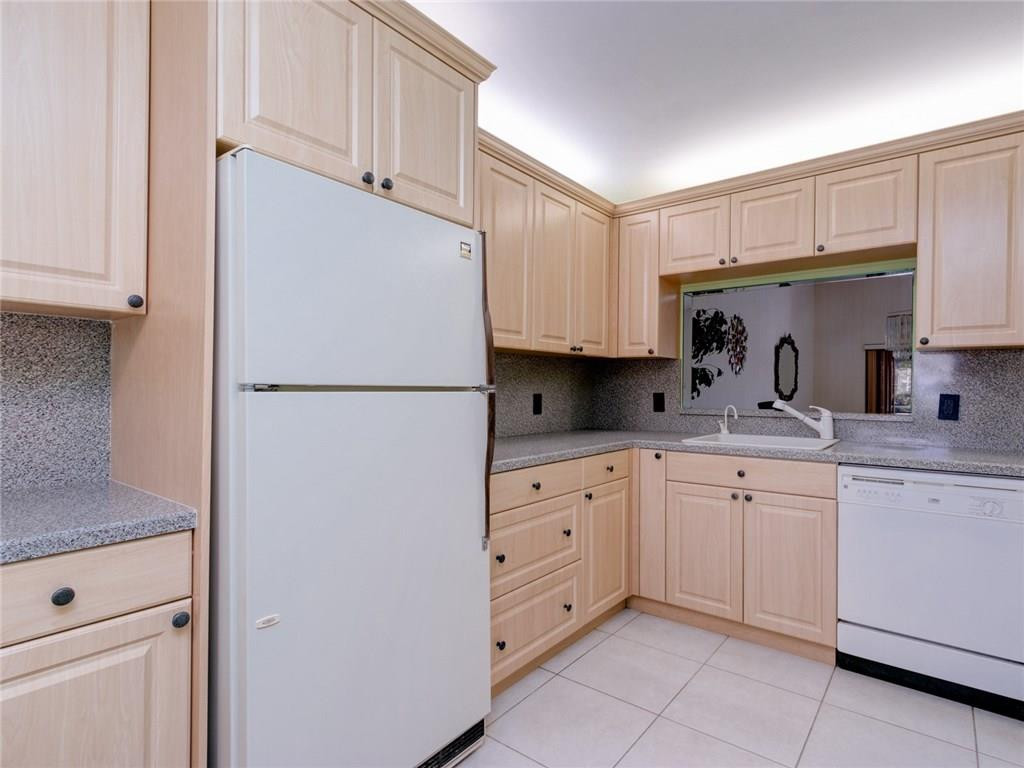 679 Racquet Club Road, Unit 4 Weston, FL 33326 - Photo 9 of 35 a kitchen with white cabinets and refrigerator