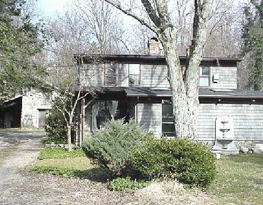 128 Perry Avenue Norwalk, CT 06850 - Photo 1 of 1 a front view of a house with a tree