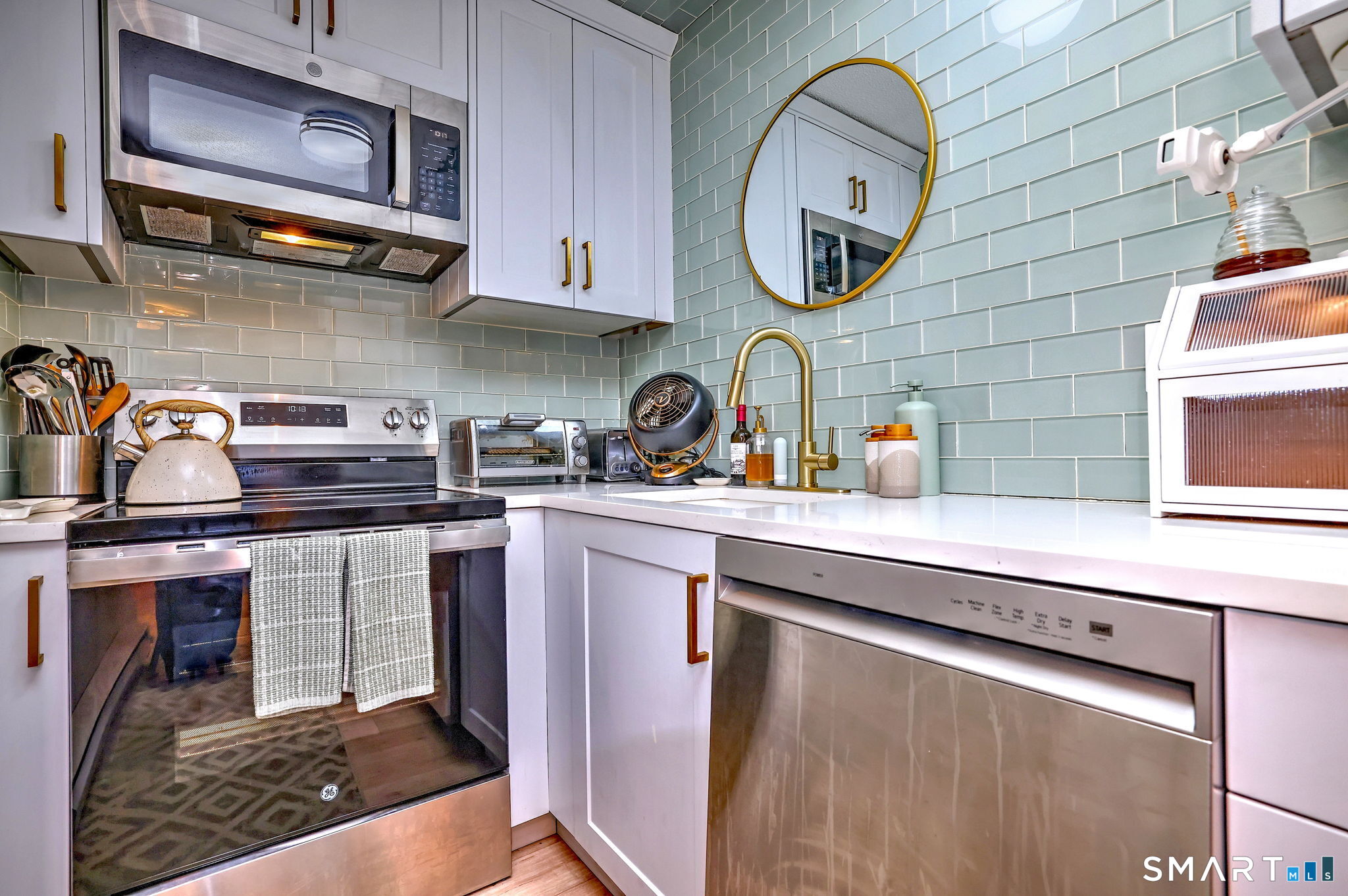 155 Short Beach Road, Unit 304 Stratford, CT 06615 - Photo 13 of 37 a kitchen with stainless steel appliances granite countertop a sink a stove and cabinets