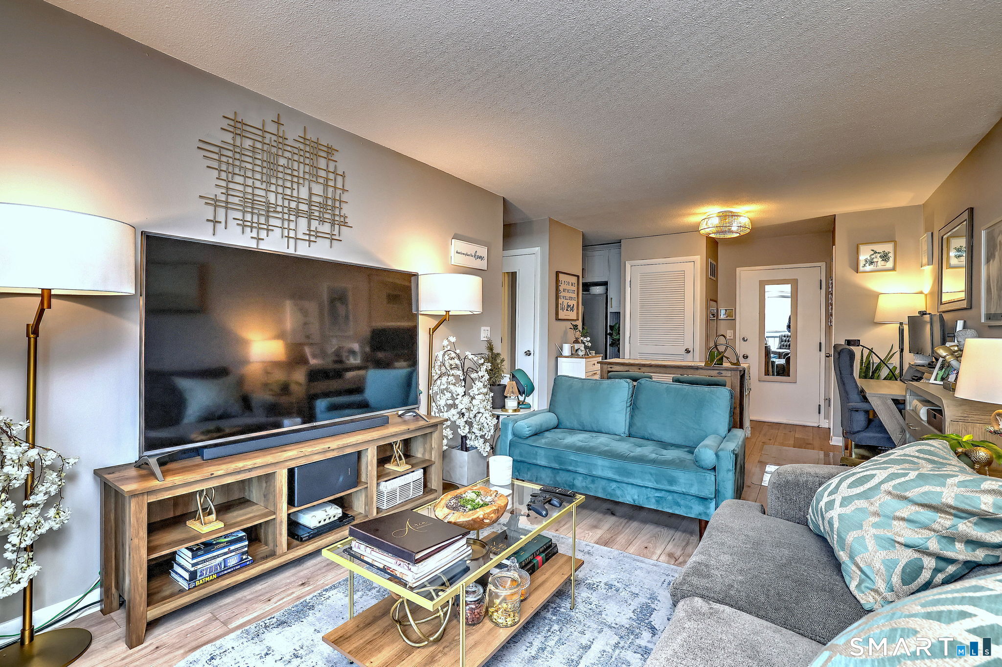 155 Short Beach Road, Unit 304 Stratford, CT 06615 - Photo 20 of 37 a living room with furniture and a flat screen tv