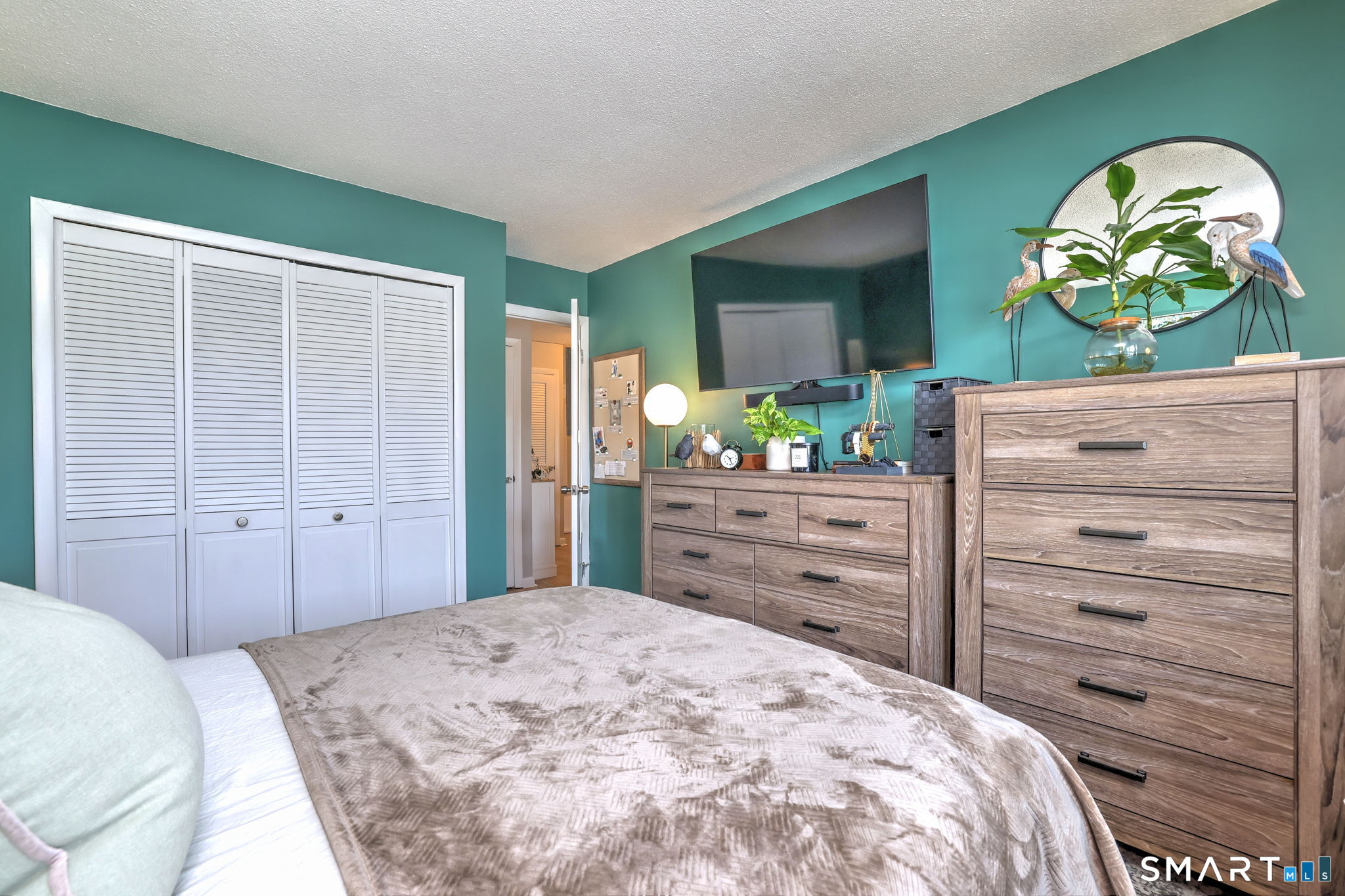 155 Short Beach Road, Unit 304 Stratford, CT 06615 - Photo 22 of 37 a bedroom with a bed and a dresser