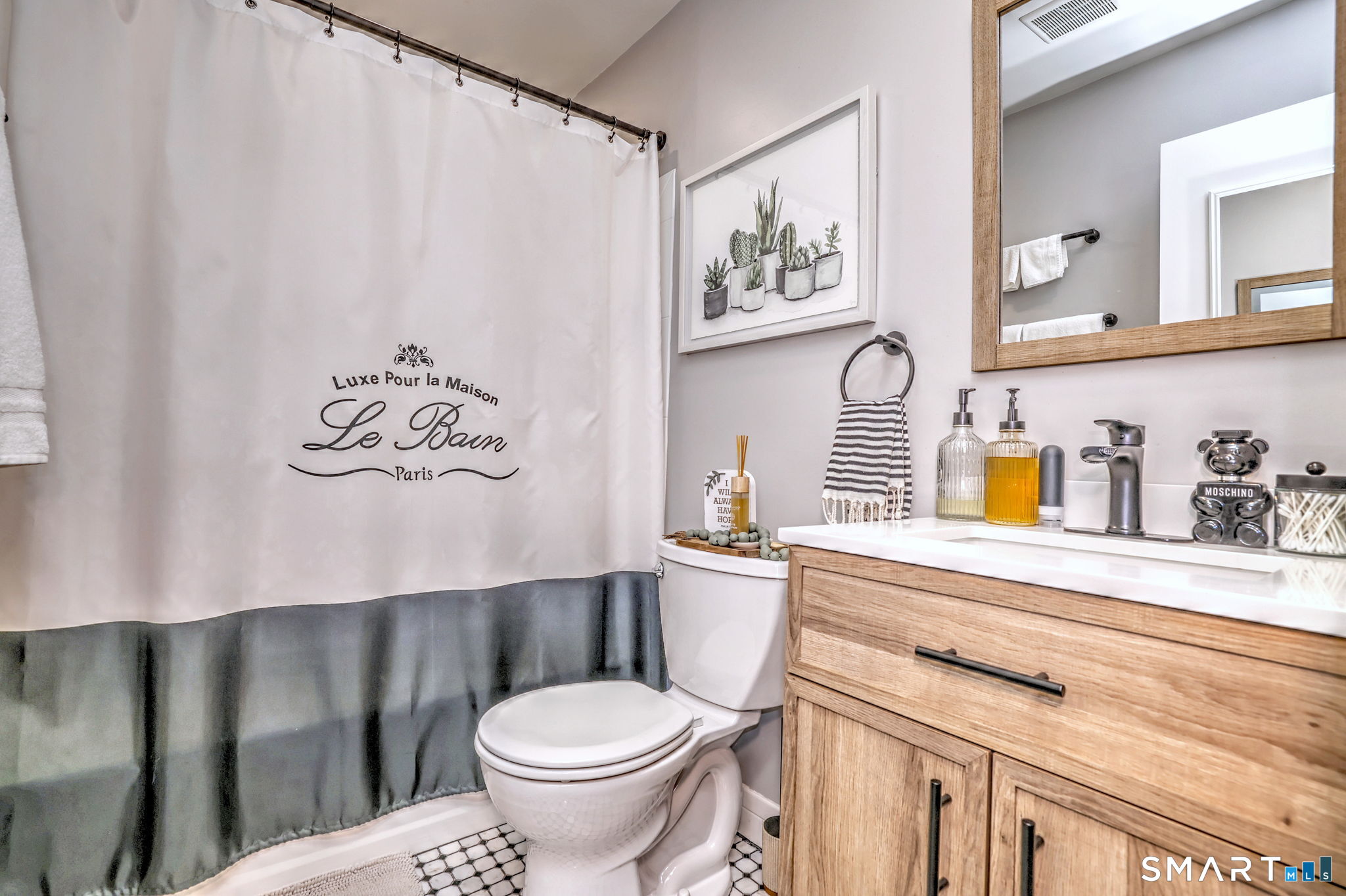 155 Short Beach Road, Unit 304 Stratford, CT 06615 - Photo 23 of 37 a bathroom with a toilet a sink and a shower curtain