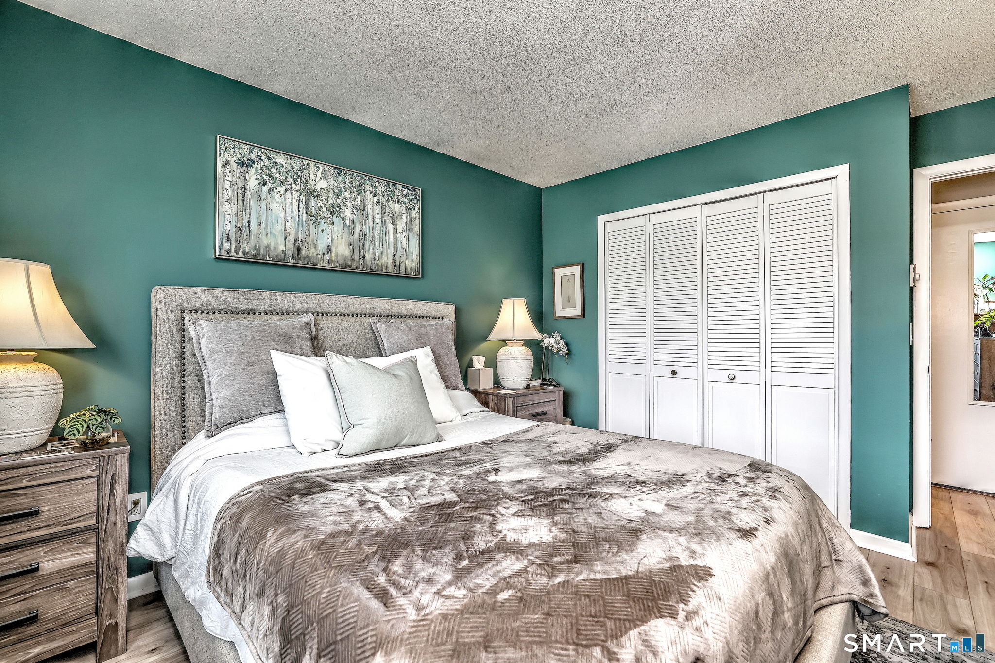 155 Short Beach Road, Unit 304 Stratford, CT 06615 - Photo 31 of 37 a large bed sitting in a bedroom next to a window