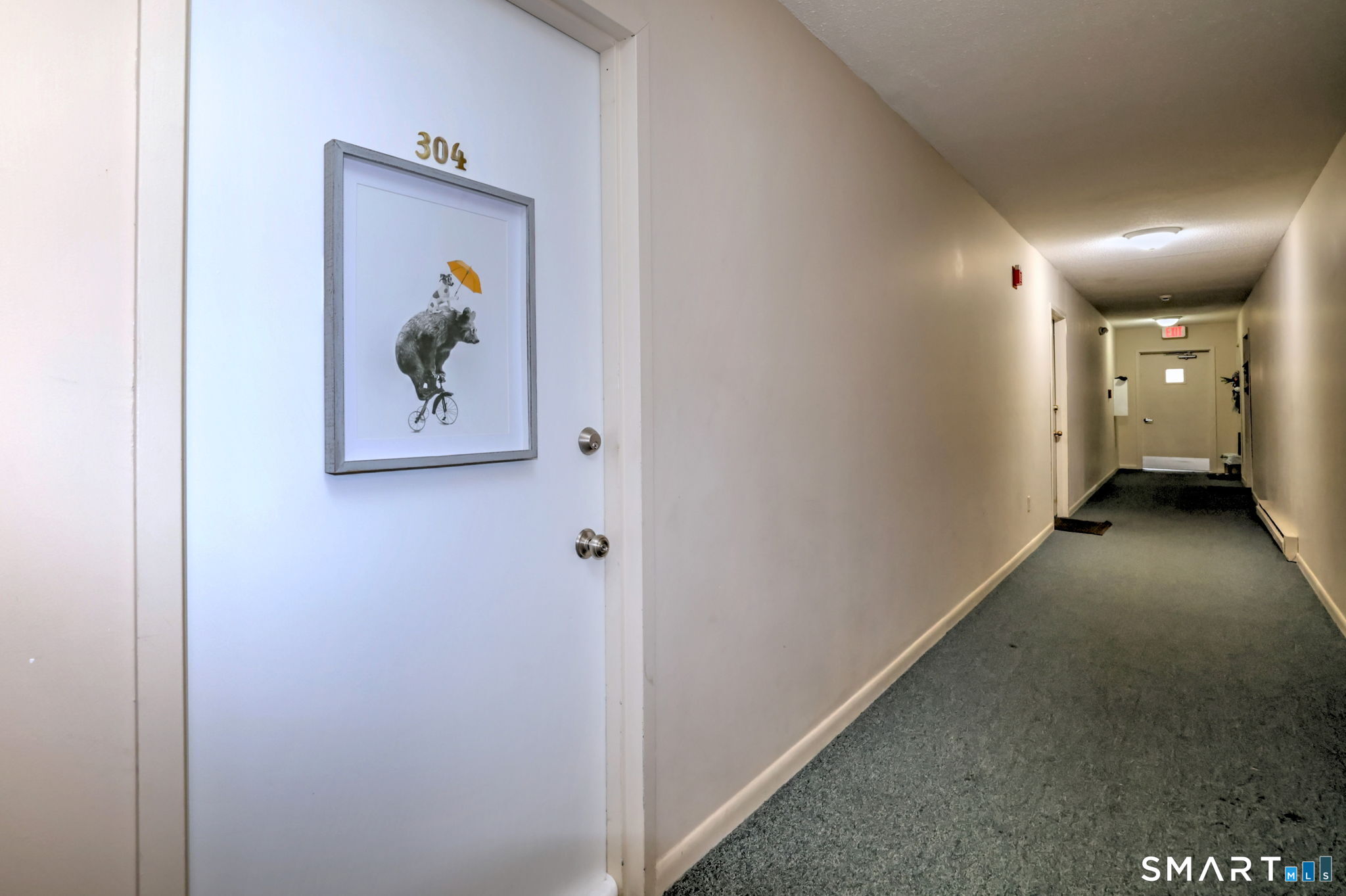 155 Short Beach Road, Unit 304 Stratford, CT 06615 - Photo 10 of 37 a view of a hallway with paintings on the wall