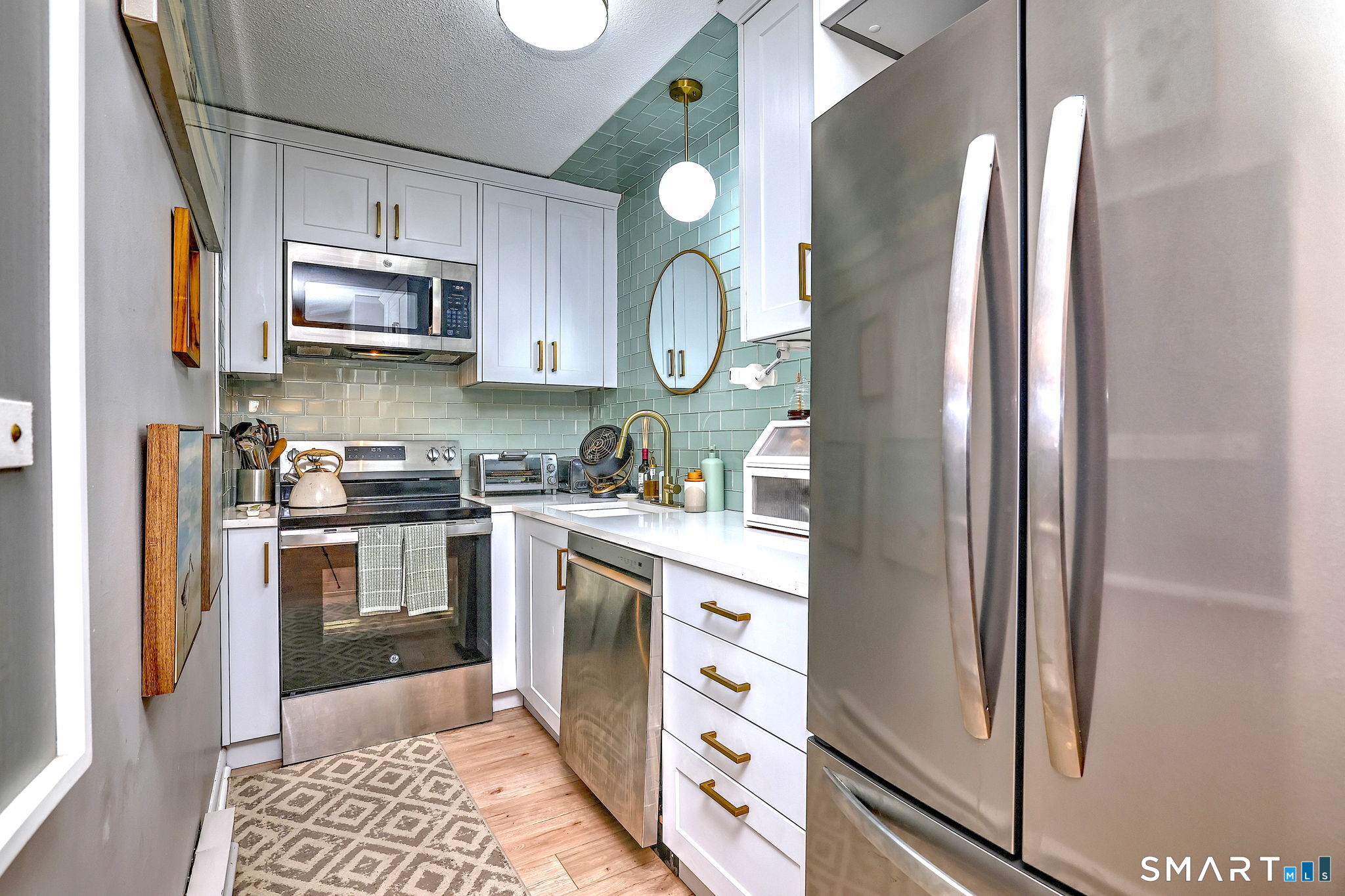 155 Short Beach Road, Unit 304 Stratford, CT 06615 - Photo 10 of 37 a kitchen with stainless steel appliances granite countertop a refrigerator sink and stove