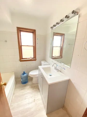 a bathroom with a sink toilet and mirror