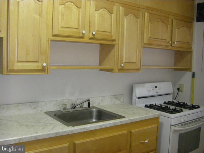 8429 Pleasant Plains Road Towson, MD 21286 - Photo 2 of 17 a kitchen with a sink and cabinets