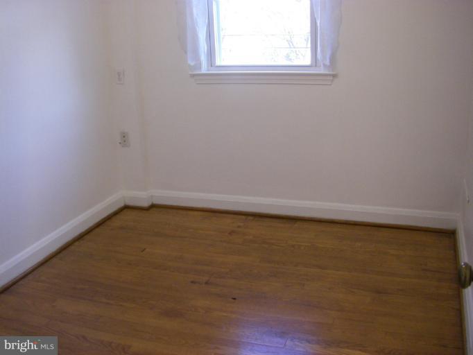 8429 Pleasant Plains Road Towson, MD 21286 - Photo 11 of 17 a view of a small space with wooden floor and a window