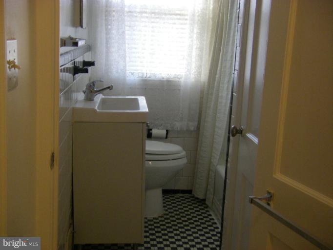 8429 Pleasant Plains Road Towson, MD 21286 - Photo 12 of 17 a bathroom with a sink a toilet and shower