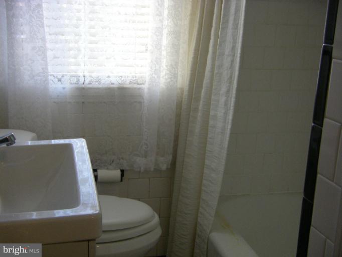8429 Pleasant Plains Road Towson, MD 21286 - Photo 13 of 17 a bathroom with a toilet and sink in it