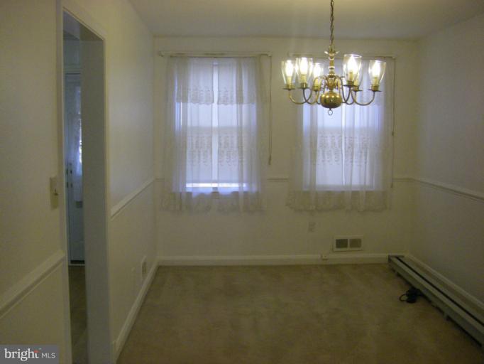 8429 Pleasant Plains Road Towson, MD 21286 - Photo 7 of 17 en empty room with windows and chandelier