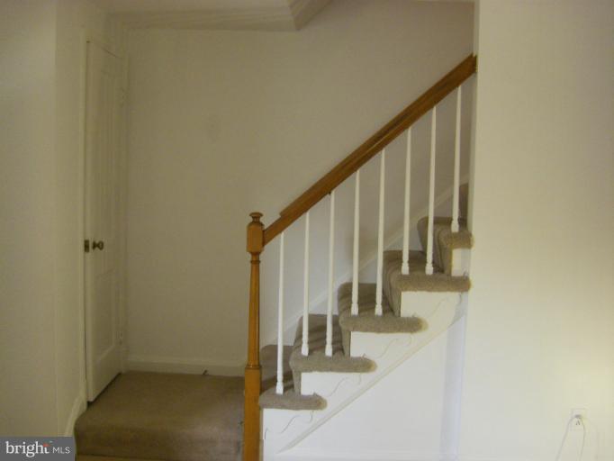8429 Pleasant Plains Road Towson, MD 21286 - Photo 8 of 17 a view of staircase with railing and white walls