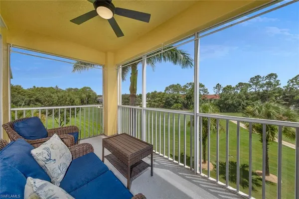 a view of a balcony with couches and wooden floor
