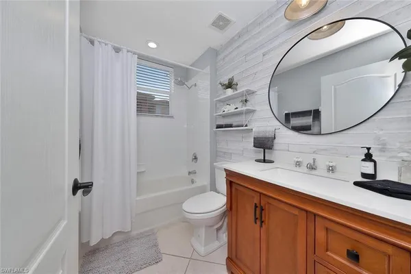 a bathroom with a double vanity sink mirror and toilet