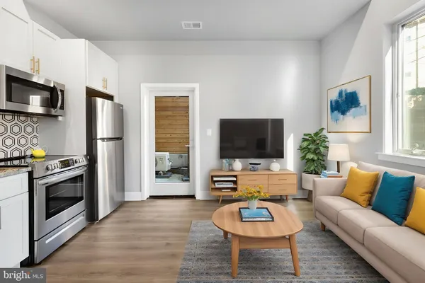 a living room with furniture a flat screen tv and a fireplace