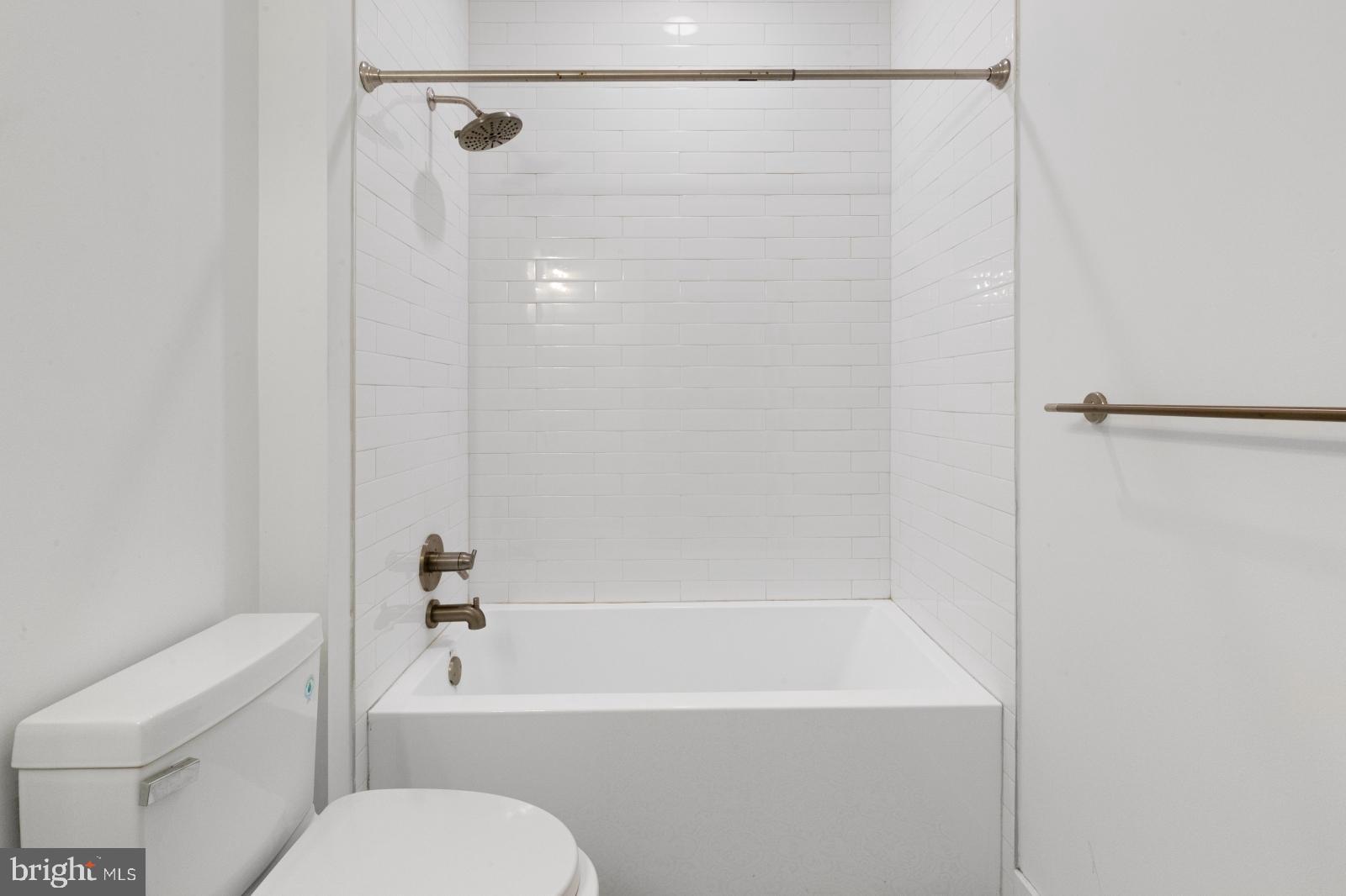 2119 North Front Street, Unit 101 Philadelphia, PA 19122 - Photo 17 of 23 a bath room with a toilet and a bath tub