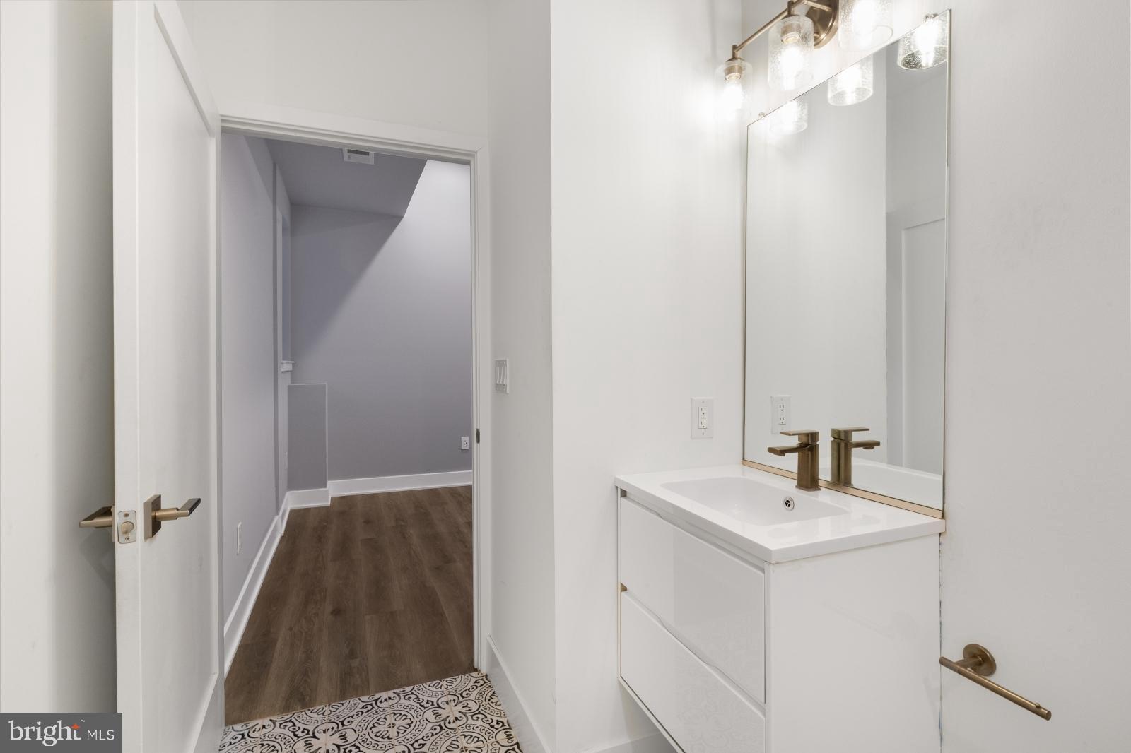 2119 North Front Street, Unit 101 Philadelphia, PA 19122 - Photo 18 of 23 a bathroom with a sink vanity and a mirror