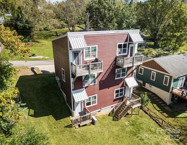 an aerial view of a house with a yard basket ball court and outdoor seating