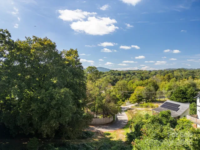 a living room with stainless steel appliances kitchen island granite countertop furniture and wooden floor