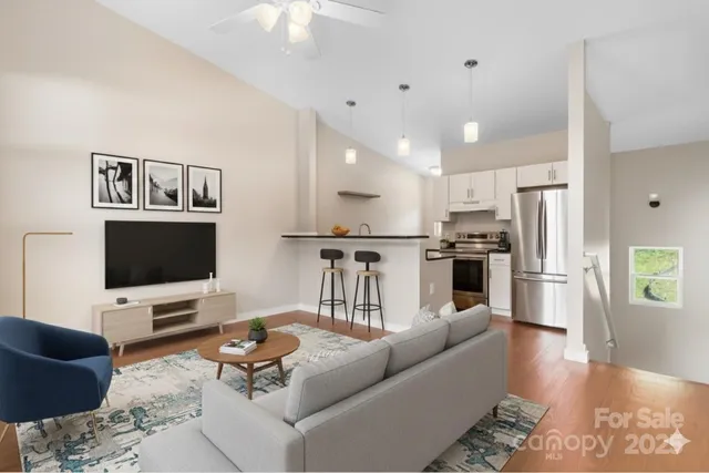 a view of kitchen with granite countertop cabinets and refrigerator