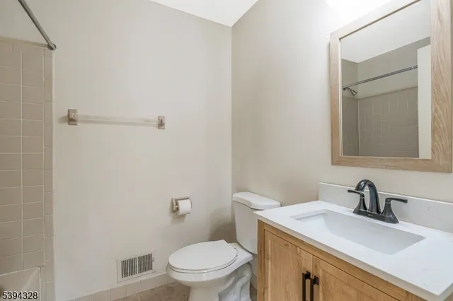 a bathroom with a sink a toilet and mirror