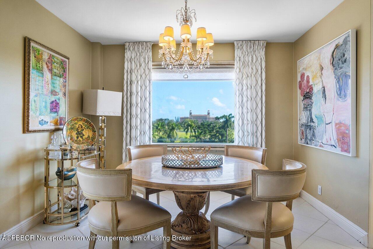 a dining room with furniture and a chandelier