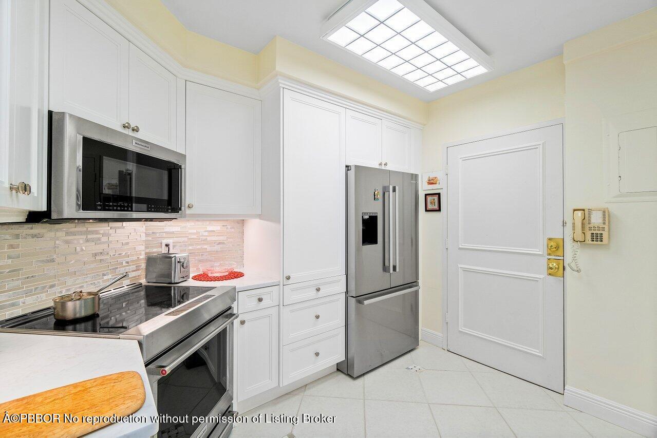 44 Cocoanut Row, Unit 505B Palm Beach, FL 33480 - Photo 7 of 14 a kitchen with stainless steel appliances a refrigerator sink and microwave