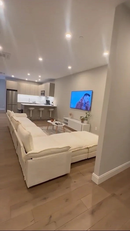 44-46 Temple Place, Unit 3 Boston, MA 02111 - Photo 1 of 11 a living room with couches and kitchen view