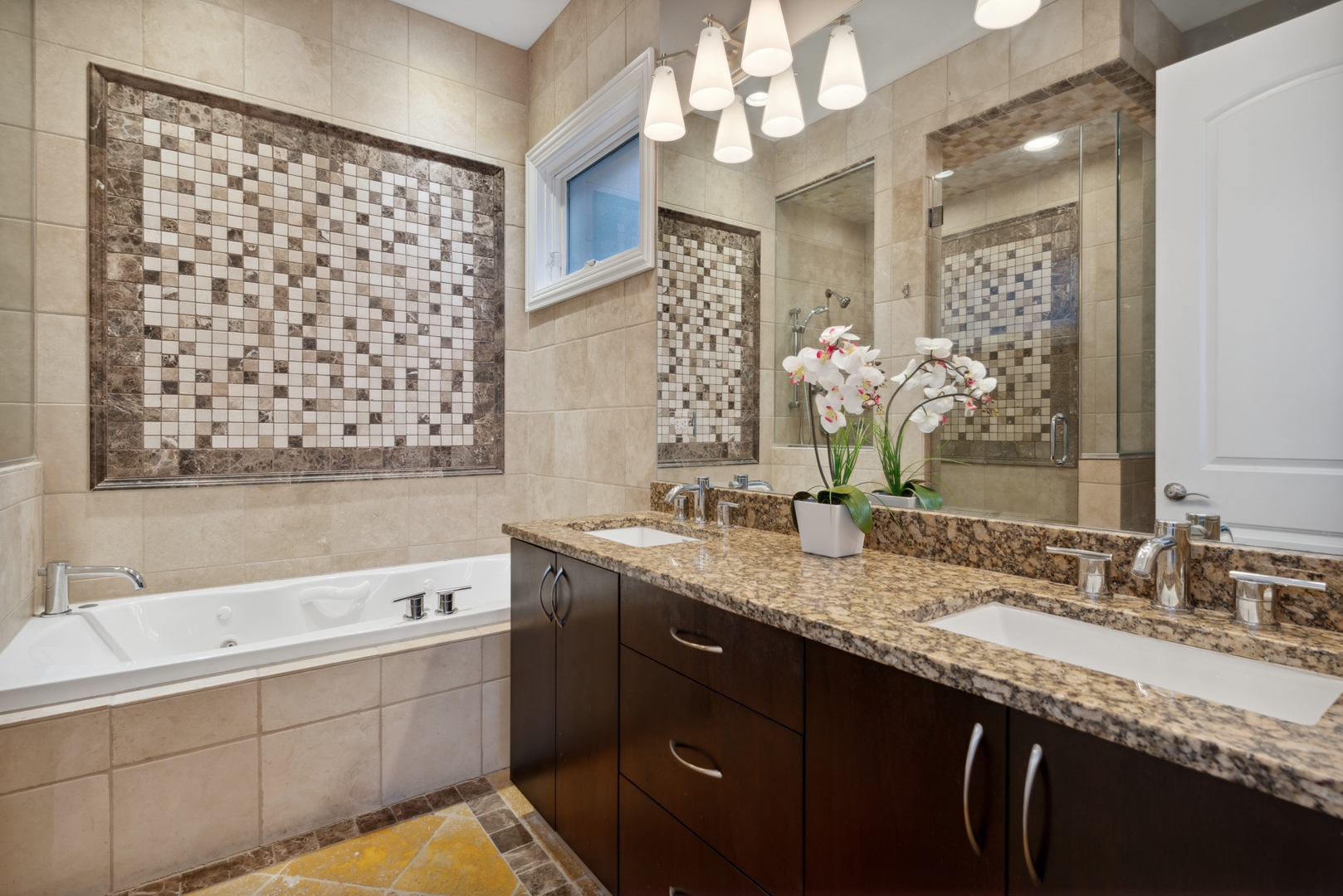 1131 West Addison Street, Unit 2 Chicago, IL 60613 - Photo 14 of 21 a bathroom with a granite countertop sink a large mirror a bathtub and shower
