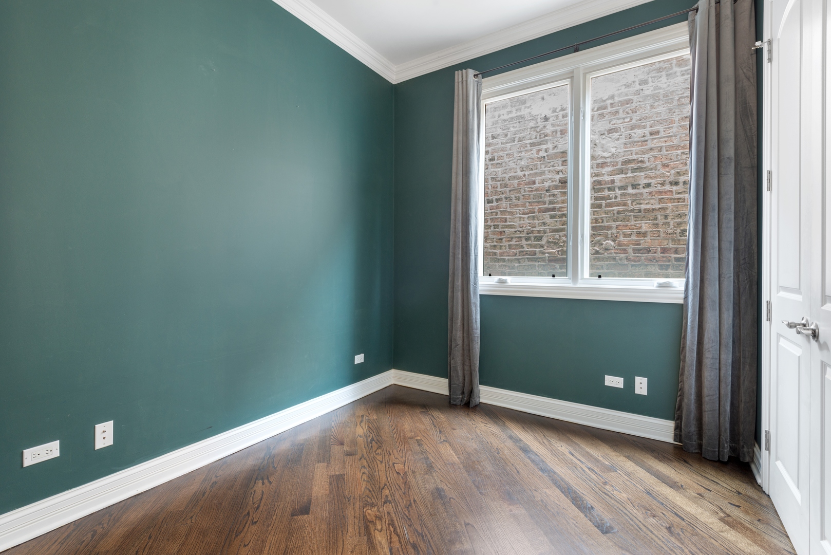 1131 West Addison Street, Unit 2 Chicago, IL 60613 - Photo 16 of 21 a view of a room with wooden floor and windows