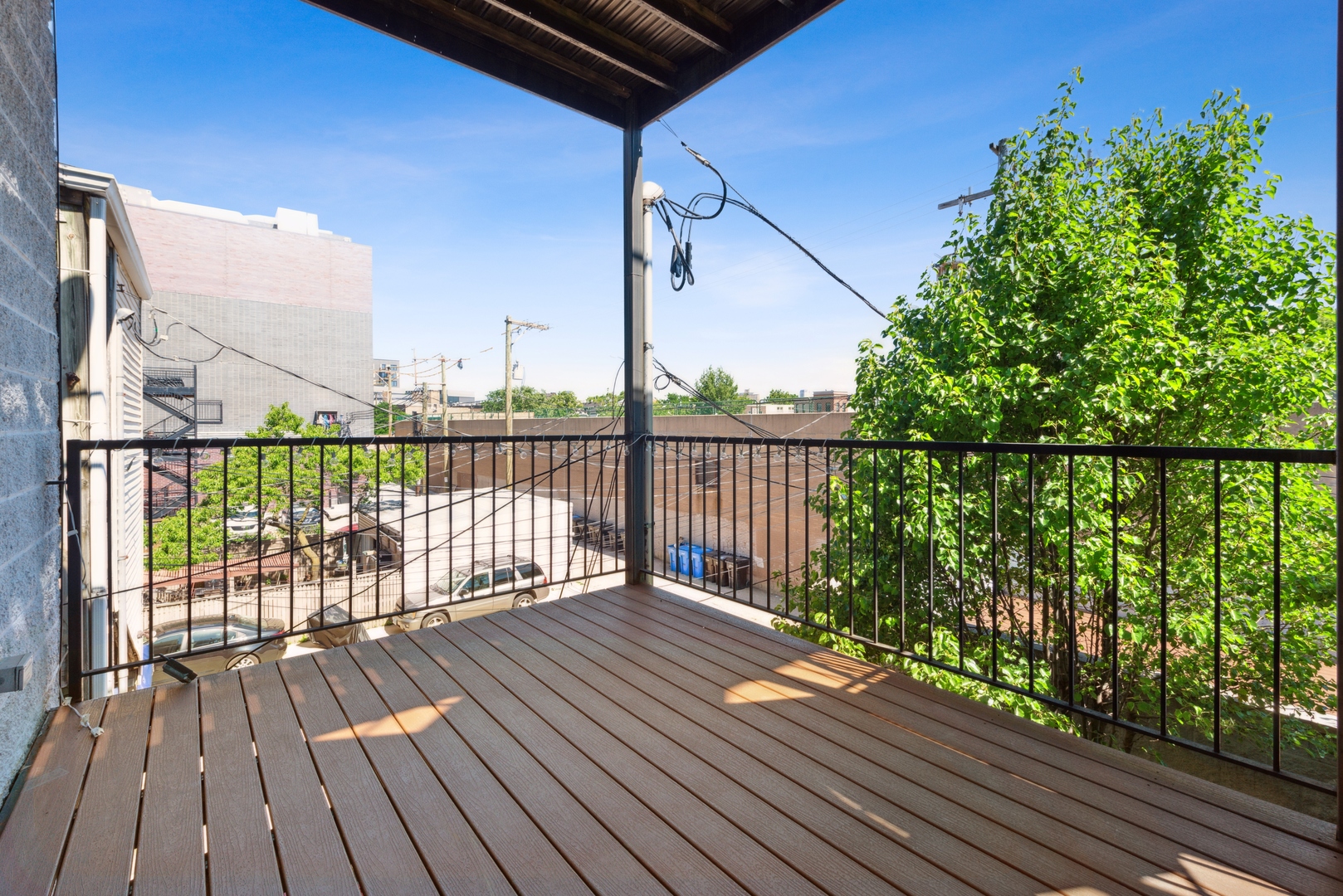 1131 West Addison Street, Unit 2 Chicago, IL 60613 - Photo 19 of 21 a balcony with wooden floor