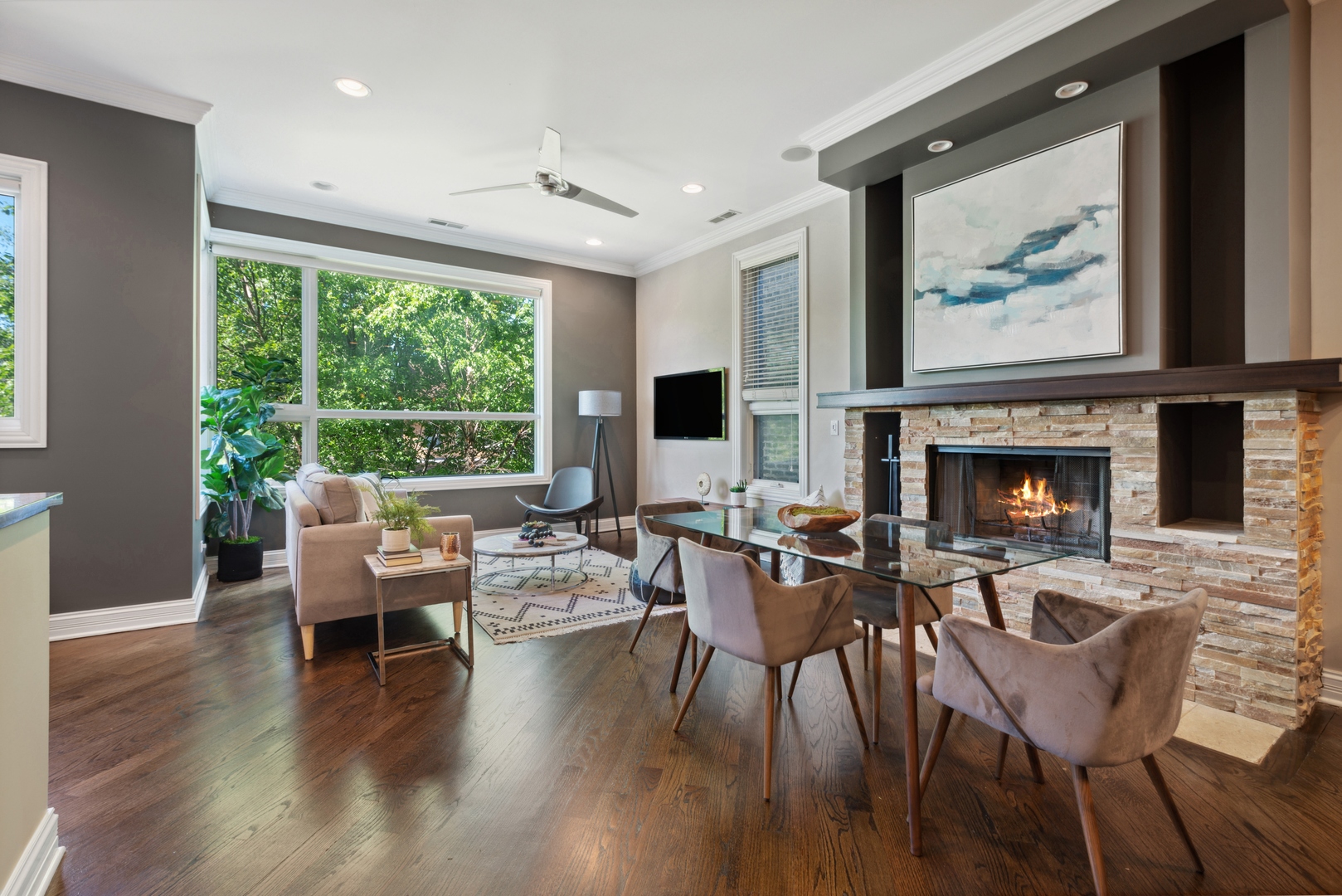 1131 West Addison Street, Unit 2 Chicago, IL 60613 - Photo 2 of 21 a living room with furniture a fireplace and a large window