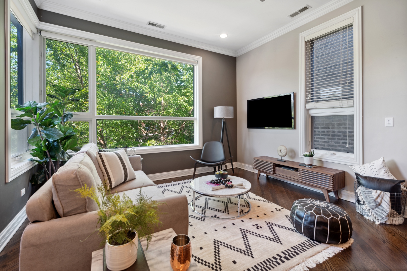 1131 West Addison Street, Unit 2 Chicago, IL 60613 - Photo 3 of 21 a living room with furniture and a flat screen tv