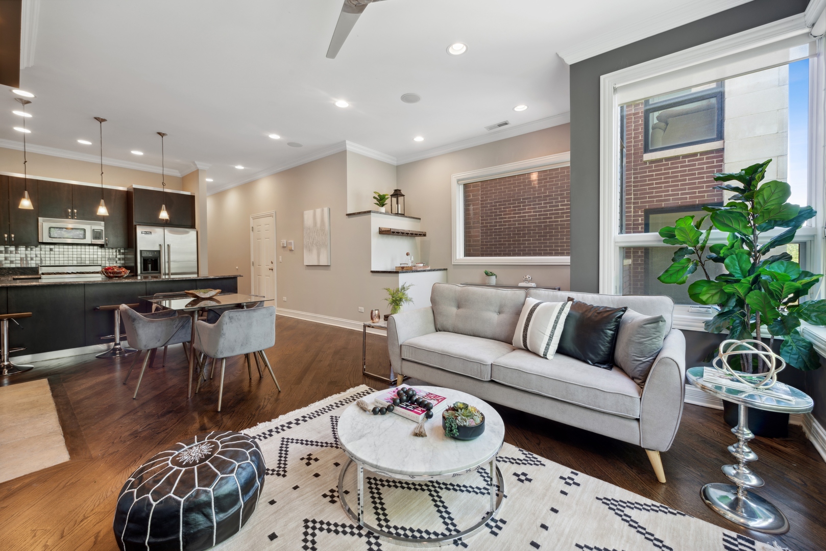 1131 West Addison Street, Unit 2 Chicago, IL 60613 - Photo 4 of 21 a living room with furniture and a dining table with kitchen view